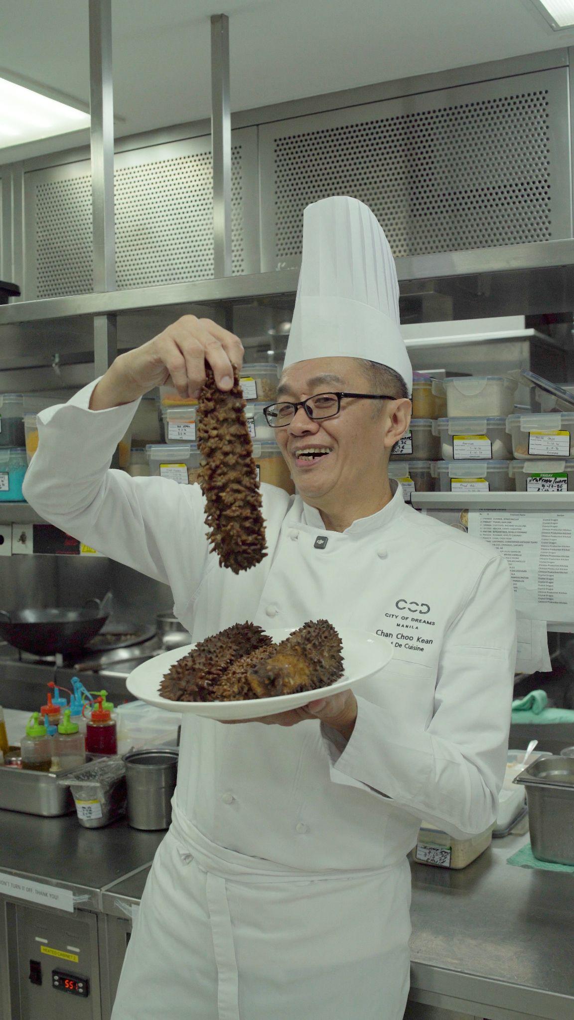 Chef Chan presenting sea cucumber in the kitchen