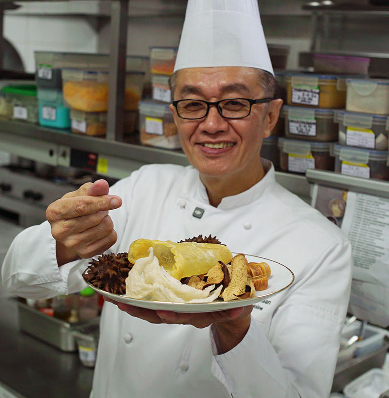 Chef Chan Choo Kean presenting dried scallops in the Crystal Dragon kitchen