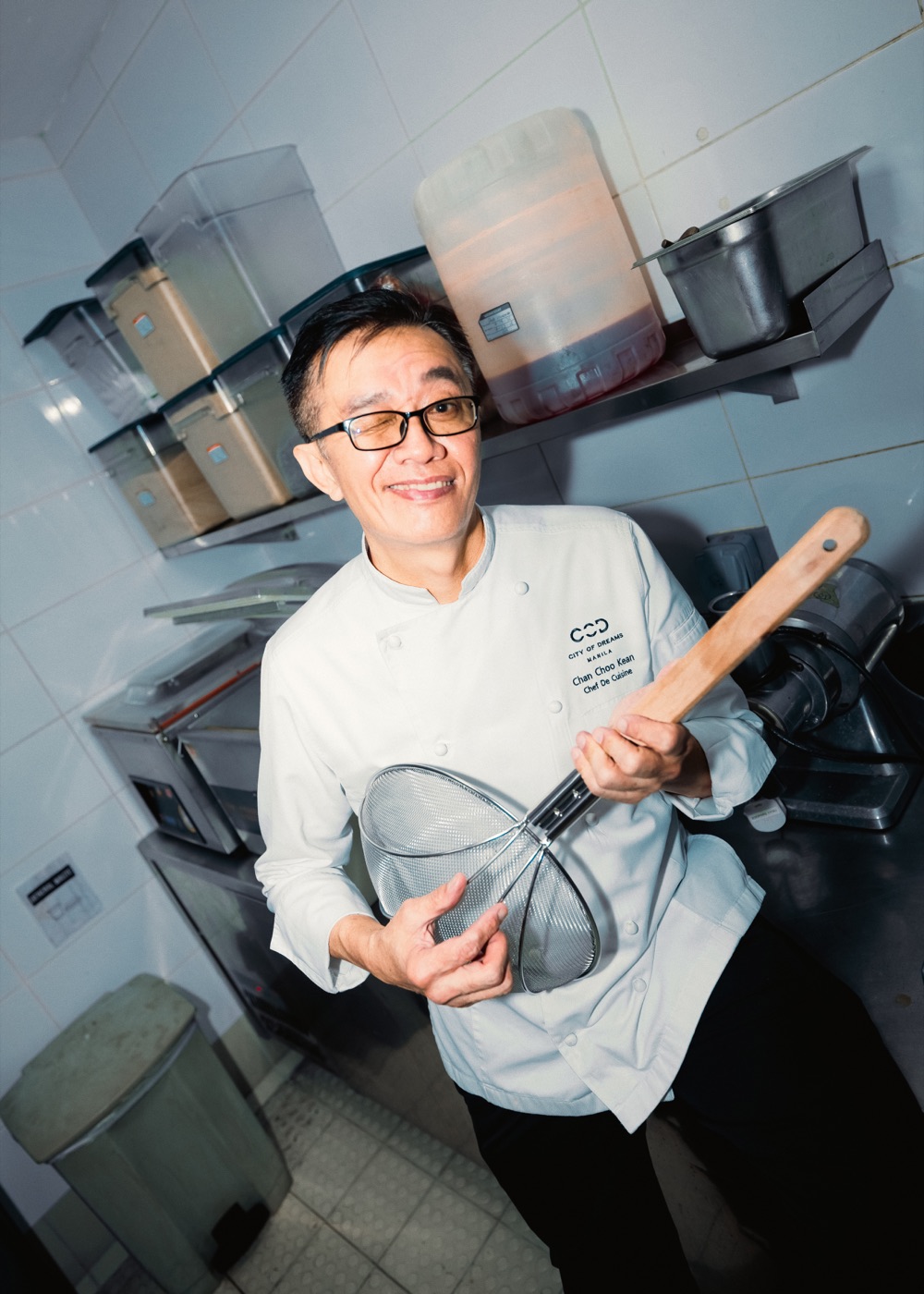 Chef Chan holding a wire spider strainer