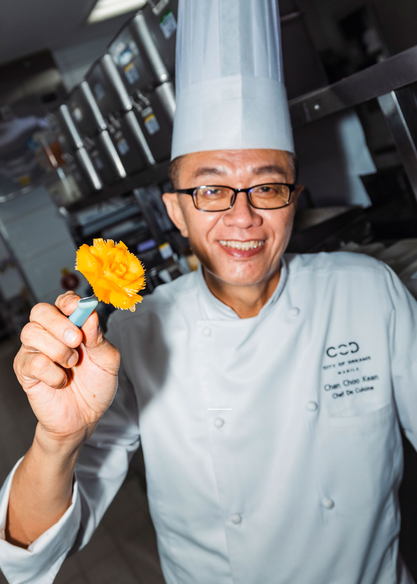 Chef Chan Choo Kean carving a carrot flower in the Crystal Dragon kitchen