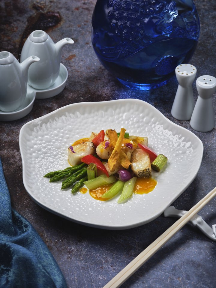 Pan-seared cod fish with vegetables and yellow pepper sauce