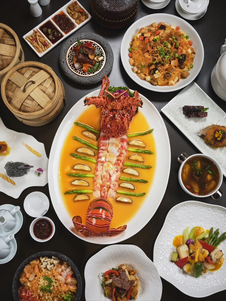 Whole lobster and seafood dishes arranged on a banquet table